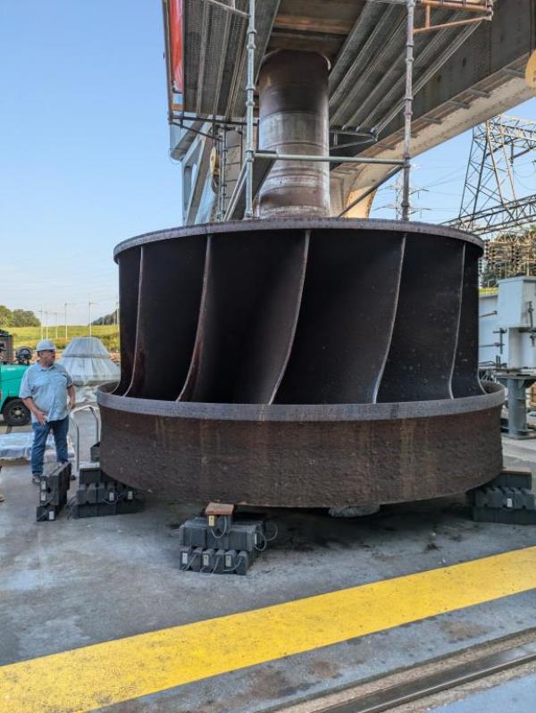 Jay Tiley inspects a hydroelectric runner from TVA's Cherokee Dam